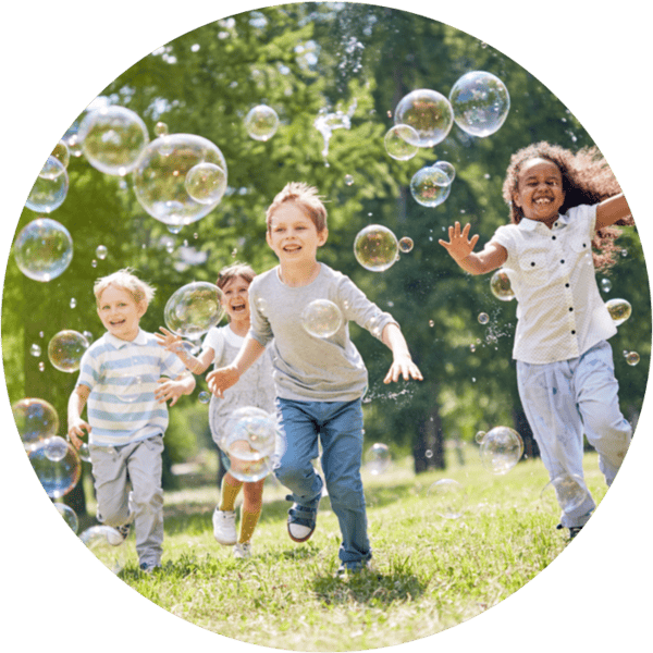 Kids running with bubbles